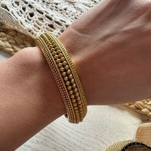 Efulgenz traditional Indian gold-toned bangle bracelet featuring a hinged design